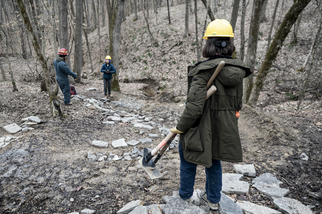 Jessie Powers, Executive Director of the Outdoor Recreation Council of Appalachia, surveys a work site on the Baileys Trail System within the Wayne National Forest. 